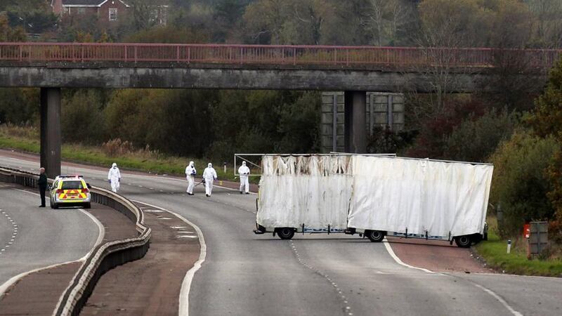 Forensic officers search the scene on the M1 motorway near the town of Lurgan in Northern Ireland where prison officer David Black was shot dead as he drove to work on November 1st last year. Photograph: Reuters