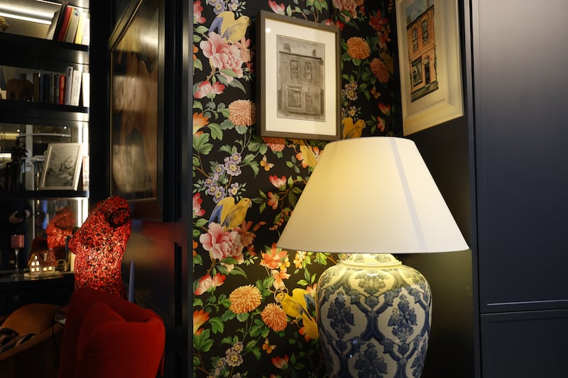 Bold floral wallpaper covers two of the ground-floor walls