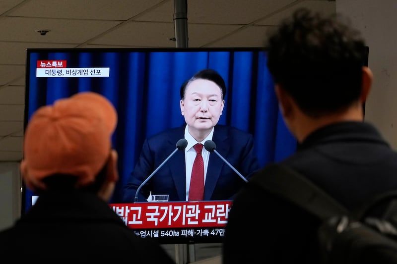 People at a bus terminal in Seoul watch a TV screen showing South Korean president Yoon Suk Yeol’s televised briefing, in which he declared martial law. Photograph: Ahn Young-joon/AP