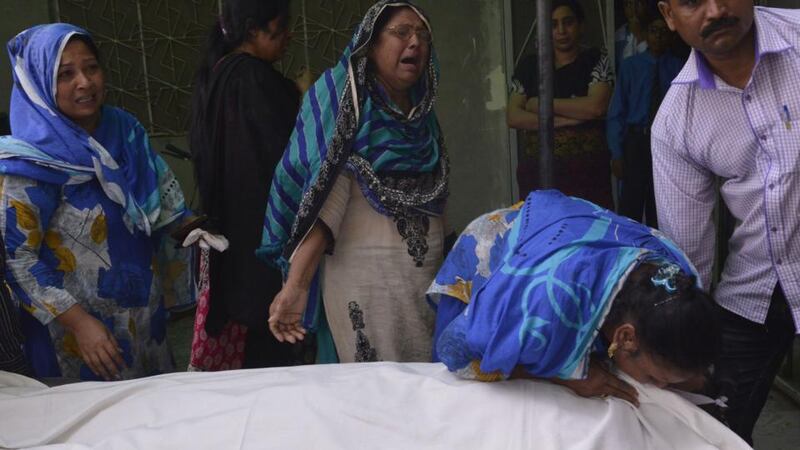 Relatives  mourn beside Aftab Bahadur’s  body after his execution in Lahore. Photograph: Arif Alia/AFP/Getty Images