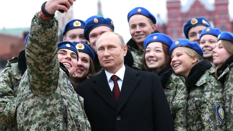 Russian president Vladimir Putin poses for a selfie with cadets in Red Square, Moscow. Photograph: Sasha Mordovets/Getty Images