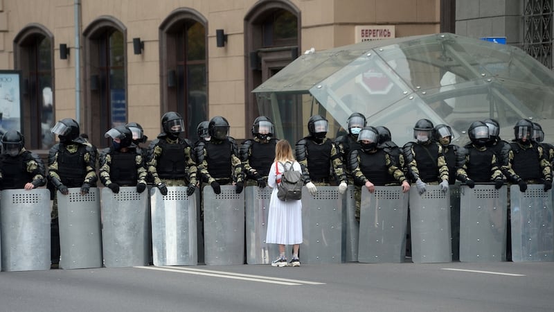 A woman approaches riot police blocking a road in Minsk, in September 2020. Photograph: Stringer/EPA