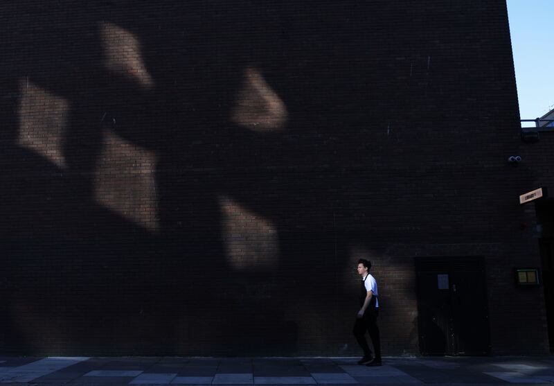 A man walks through autumnal light near the junction of Frederick Street South and Setanta Place in Dublin. Photograph: Bryan O’Brien