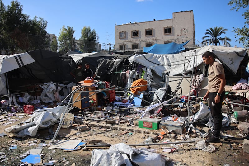 Palestinians inspect the damage following Israeli bombardment which hit a camp for displaced people from other parts of northern Gaza inside the Al-Jazira Sports Club in Gaza City on November 12th. Photograph: Omar Al-Qattaa/AFP via Getty