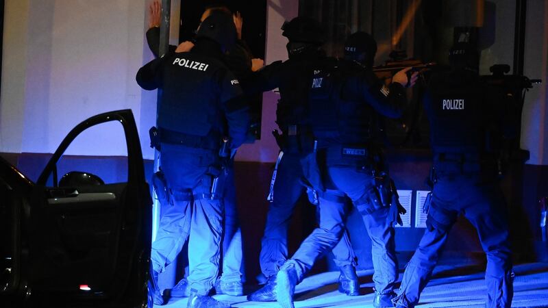 Austrian policemen search a civilian  after gunfire in Vienna, Austria. Photograph: Christian Bruna/EPA