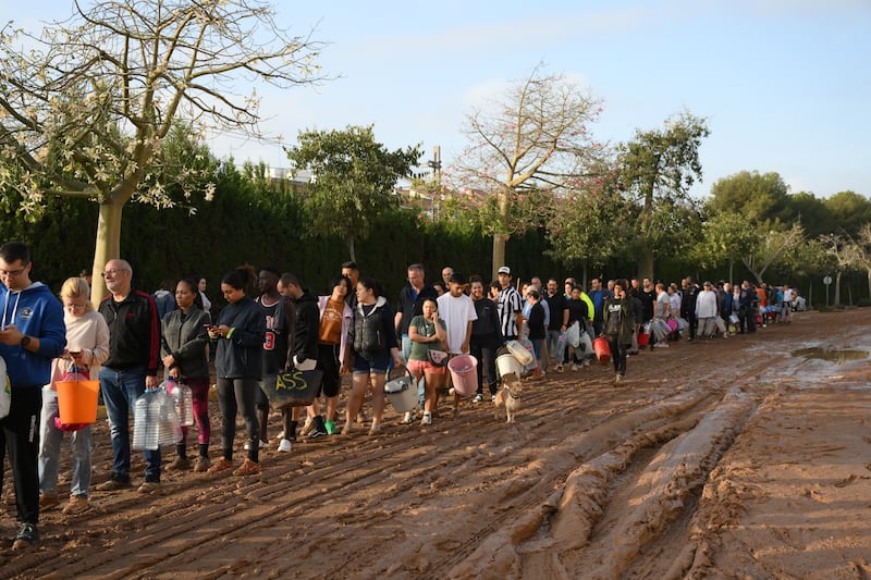 People line up to collect water from a broken pipe in the Paiporta area of Valencia, Spain. Photograph: David Ramos/Getty Images