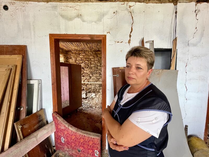 Oksana Kuzminskaya in her house in Snihurivka. She and her family were at home when a Russian bomb fell on their street, badly damanging the house. The town is now suffering from floods caused by the Kakhovka dam destruction. Photograph: Daniel McLaughlin