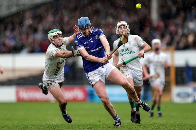 Thomastown's John Donnelly scores a point despite the best efforts of Paddy Deegan of O'Loughlin Gaels in the Kilkenny final where Thomastown produced an upset as they continued their rapid rise by claiming the county title. Photograph: Laszlo Geczo/Inpho 