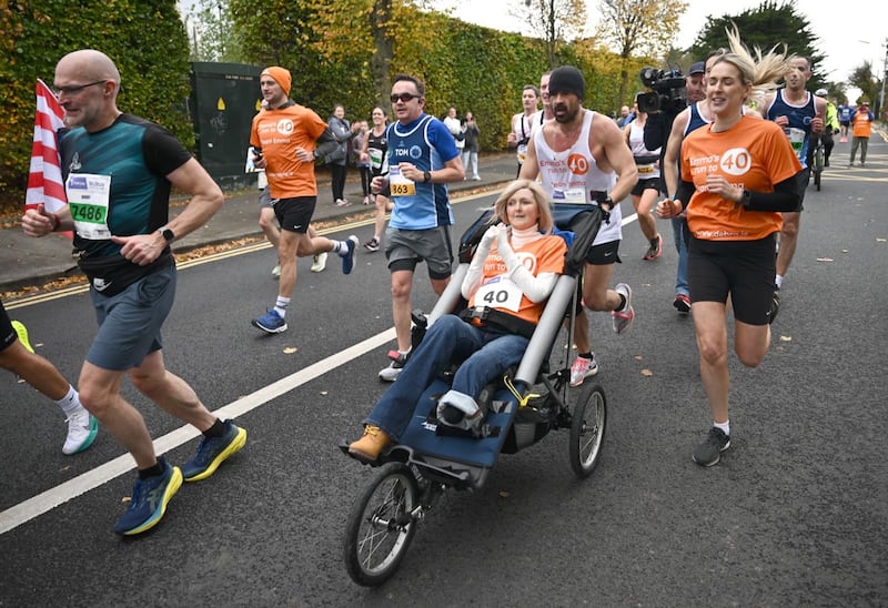 Actor Colin Farrell with his close friend Emma Fogarty, running in the Irish Life Dublin Marathon in Dublin to raise money for people living with Epidermolysis Bullosa