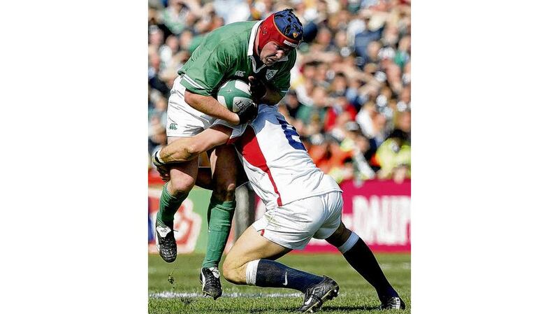 Anthony Foley being tackled by Lawrence Dallaglio during the Grand Slam match of 2003. photographs: inpho