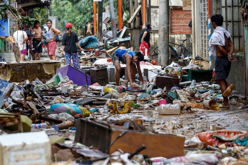 Residents manage the clean up of a street a day after massive flooding in Marikina City, Metro Manila, in the Philippines, from monsoon rainfall caused by typhoon Gaemi. Photograph: Rolex Dela Pena/EPA