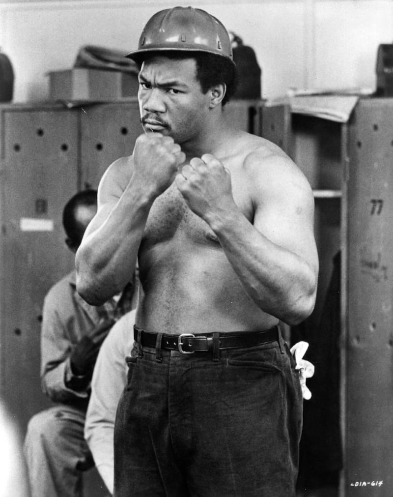 George Foreman gets tough in Warner Brothers' Let's Do It Again, directed by Sidney Poitier, in June 1976. Photograph: Evening Standard/Getty Images