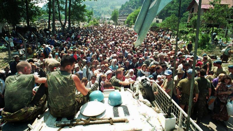 Dutch UN peacekeepers atop an armoured personnel carrier as Muslim refugees from Srebrenica gather in the nearby village of Potocari in July 1995. File photograph: AP