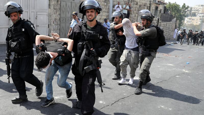 Israeli security forces arrest Palestinian men following clashes outside Jerusalem’s Old City. Photograph:  Ammar Awad/Reuters