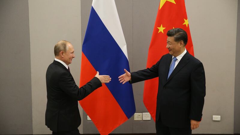 Vladimir Putin greets Xi Jinping at a  meeting in Brazil in November  2019. Photograph: Mikhail Svetlov/Getty Images