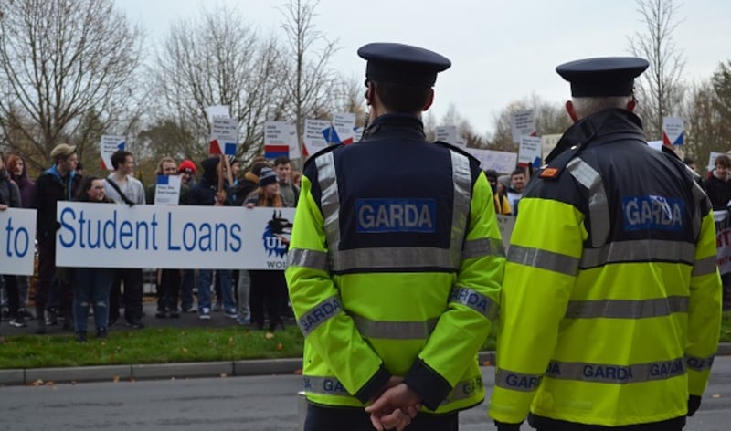 Gardaí watch as protesters gather outside the Analog Devices building. Photograph: Paul Saunders