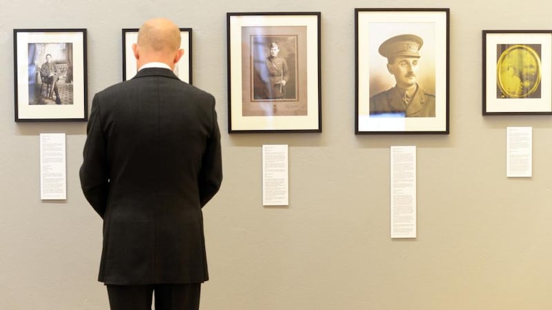 British Ambassador Dominick Chilcott examining photographs at the exhibition, ‘Portraits of the Invisible’, a selection of first World War images, at the National Photographic Archive in Temple Bar, Dublin. Photograph: Eric Luke