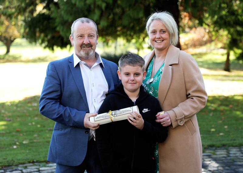 Brian Boyle (left) with his godson, Tyler and his niece, Aisling. Brian received a silver medal and a certificate of bravery for saving a woman from a house fire. Photograph: Maxwells