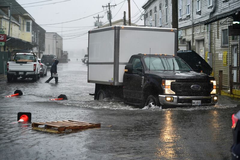 A delivery truck drives through floodwaters on the Portland, Maine, waterfront during the powerful winter storm on Friday. Photograph: Robert F Bukaty/AP