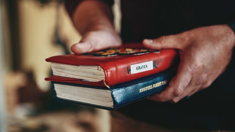 Lt Ryan Graves with his US navy   flight log books. Photograph: Tony Luong/The New York Times