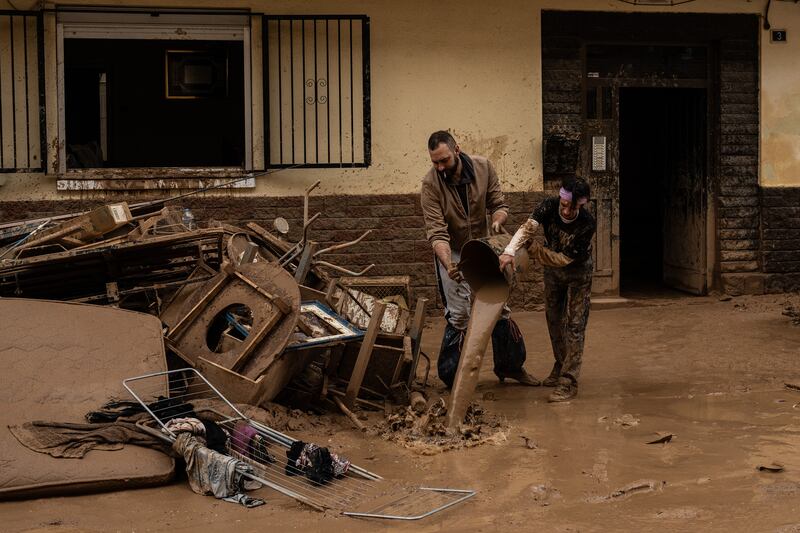 People clear mud and possessions from their homes after the recent flash flooding in the municipality of Alfafar, Valencia on Friday. Photograph: David Ramos/Getty Images