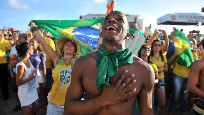 Team spirit: soccer fans watch Brazil’s World Cup match with Mexico on giant screens in Salvador. Photograph: Ibrahim Yakut/Anadolu Agency/Getty