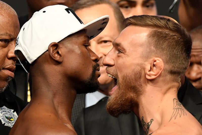 Floyd Mayweather Jr and UFC lightweight champion Conor McGregor face off during the official weigh-in at T-Mobile Arena in Las Vegas. Photograph: Ethan Miller/Getty Images