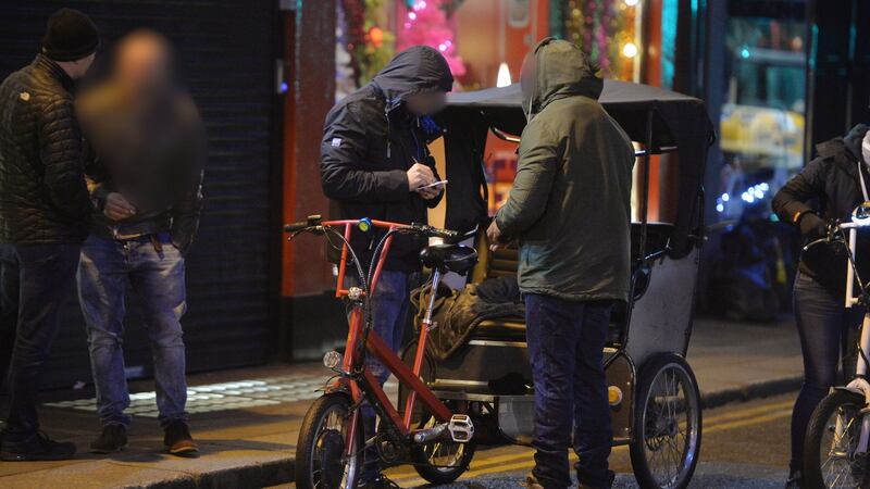 Undercover gardaí search a rickshaw driver on Dublin’s Suffolk Street after observing a drug deal.  Photograph: Alan Betson