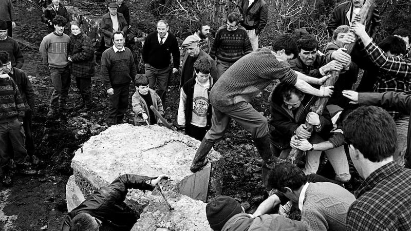 People trying to shift blockages put in place by British forces. Photograph: Copyright  Tony O’Shea