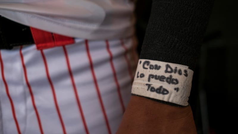 A Cayey Toritos player’s message reads “With God I can do it all”. Photograph: Dennis M Rivera Pichardo/The New York Times