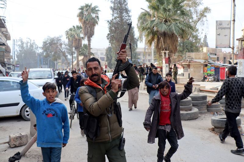 A Syrian Democratic Forces fighter celebrates with residents after it took control of the city of al-Hasakah, northeast Syria. Photograph: Ahmed Mardnli/EPA
 