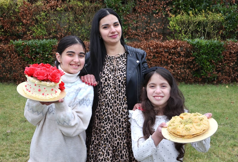 Eyvon Bastouri with her daughters Anitta and Natasha and some of her baked goods she makes. Photograph: Joe O'Shaughnessy