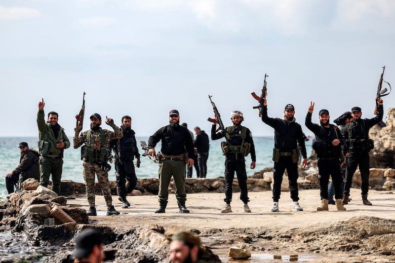 Members of security forces loyal to the interim Syrian government led by Ahmed al-Sharaa pose with their firearms in the western city of Latakia on March 9th. Photograph: Omar Haj Kadour/AFP via Getty Images    