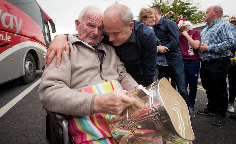 Galway manager Micheál Donoghue shows the Liam MacCarthy to his mather Miko during Galway’s homecoming at Ballinasloe in September 2017. Photograph: Morgan Treacy/Inpho