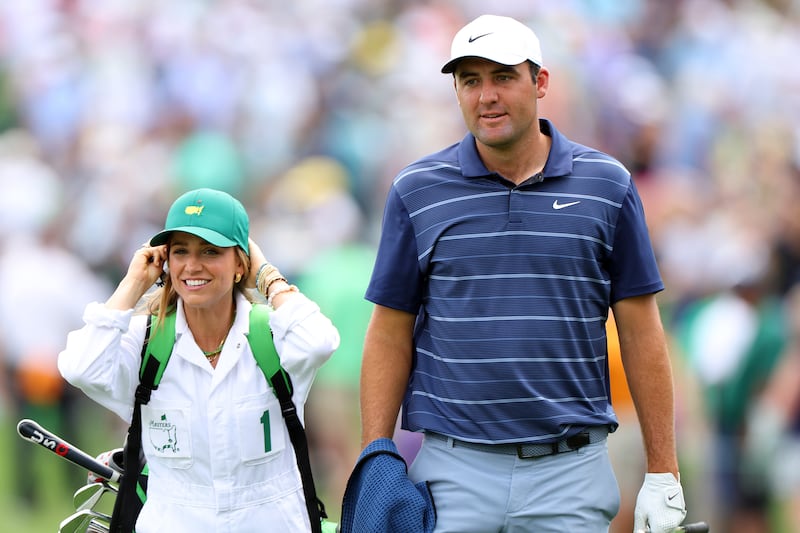 Scottie Scheffler, one of the new 'Big Three' along with McIlroy and Jon Rahm, walks up the fairway with his wife, Meredith Scheffler, during the Par 3 competition prior to the 2023 Masters Tournament at Augusta National in Georgia. Photograph: Andrew Redington/Getty Images