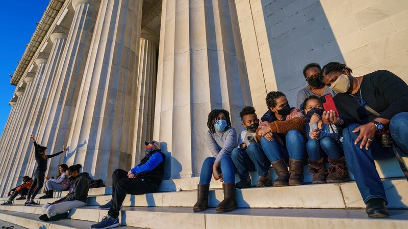 The Mundy-Cole family, right, and others gather at the Lincoln Memorial at dawn/ Photograph:J. Scott Applewhite/AP