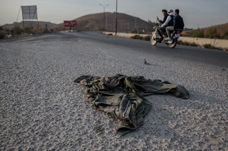 Abandoned military fatigues on the roads outside Damascus, following the fall of the Assad regime. Photograph: Sally Hayden