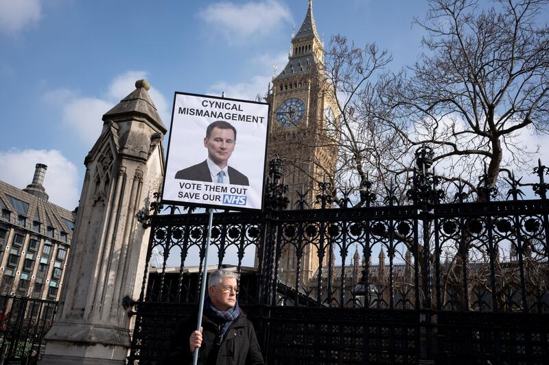 A protestor outside parliament in London on Wednesday, the day Jeremy Hunt announced his pre-election budget. Photograph: Richard Baker/In Pictures via Getty Images