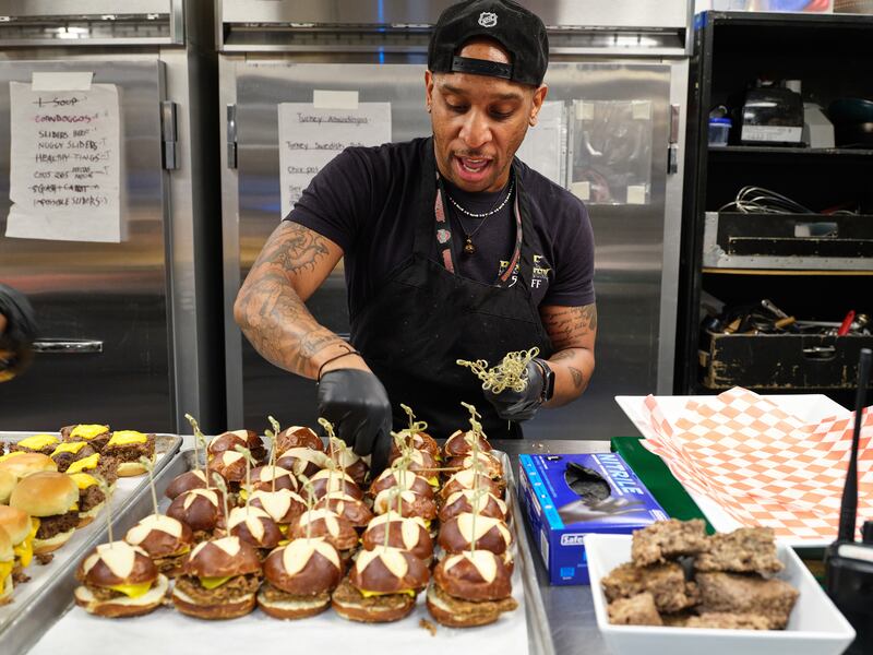 Jacob Curry puts some finishing touches on a sandwich spread at a Lizzo show in Palm Desert, California. Photograph: Michelle Groskopf/the New York Times