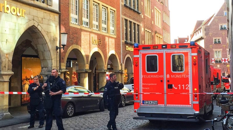 Firefighters stand in downtown Muenster. Photograph: EPA