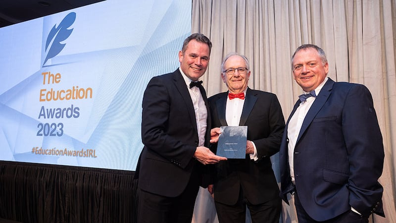 Dr Matt Cotterell, awards judge, presents the Best Library Team award to Shane Mooney and Eddie Ormonde, Dublin Business School