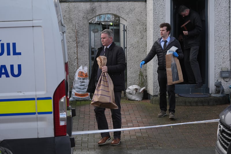 Members of the Garda carry evidence bags at the scene of a property on Hand Street in Drogheda, Co Louth. Photograph: PA