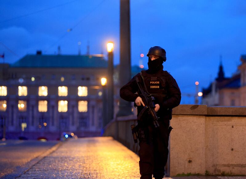 An armed police officer stands guard near the scene of the shooting at Charles University. Photograph: Martin Divisek/EPA