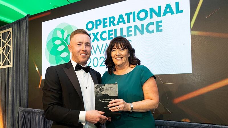 Mark M Cullen, senior project manager at Sensori FM, presents the operational excellence in warehousing to Joanne Mellon, BWG Foods