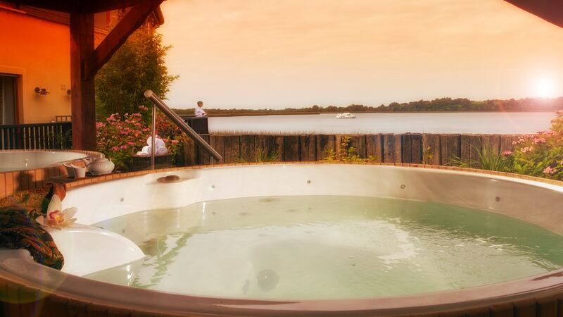 Ease away aches and pains in the hot tub overlooking the Shannon at the Wineport Lodge.