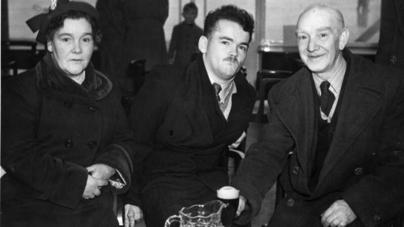 Christy Brown in Dublin Airport in 1954 with his mother and father