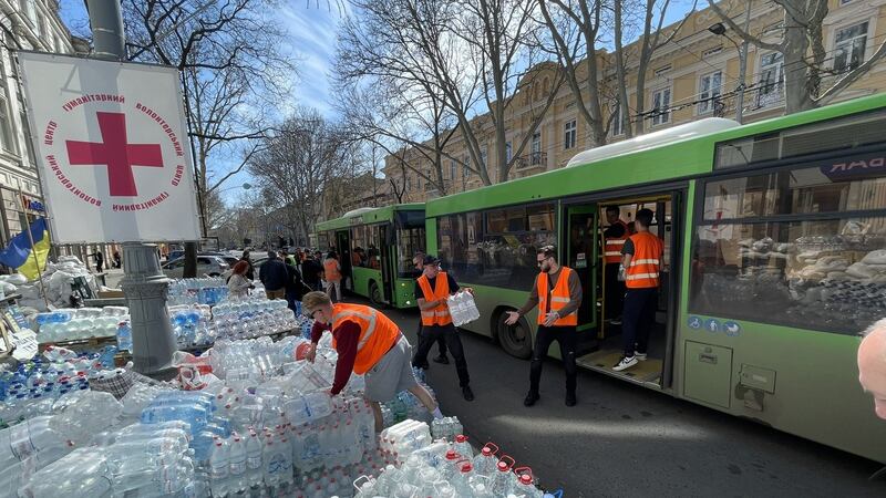 Buses evacuate children from the frontline city of Mykolaiv to Odesa and return carrying tonnes of donated bottled water. Photograph: Daniel McLaughlin