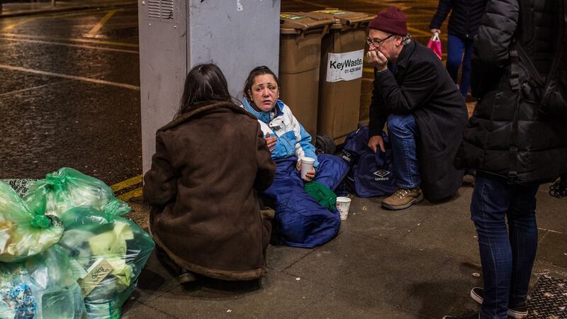 The outreach team from the Simon community group speak to a homeless woman on Dame Street in Dublin. Photograph: James Forde