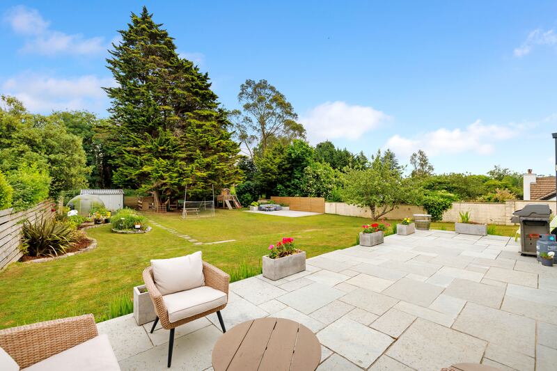 A deep granite patio runs the width of the house