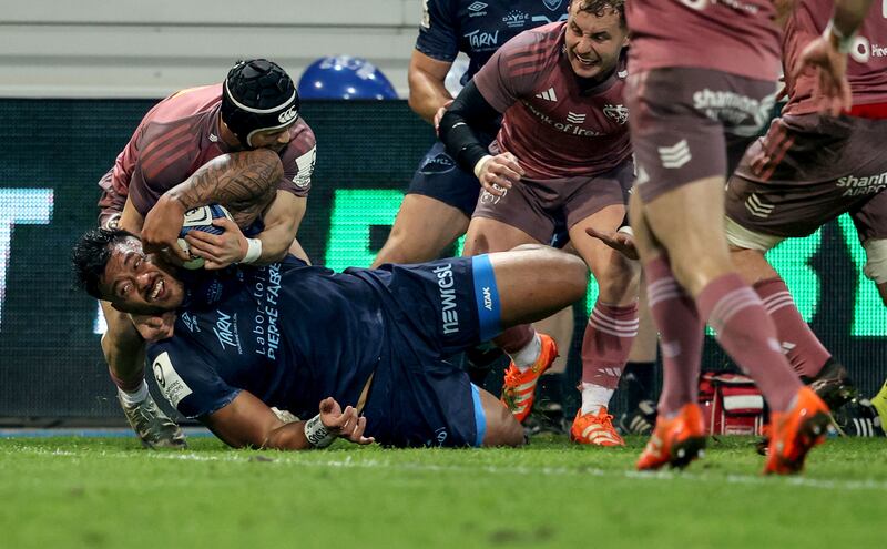 Castres’ Abraham Papalii scores their first try despite the efforts of  Thaakir Abrahams of Munster. Photograph: Dan Sheridan/Inpho